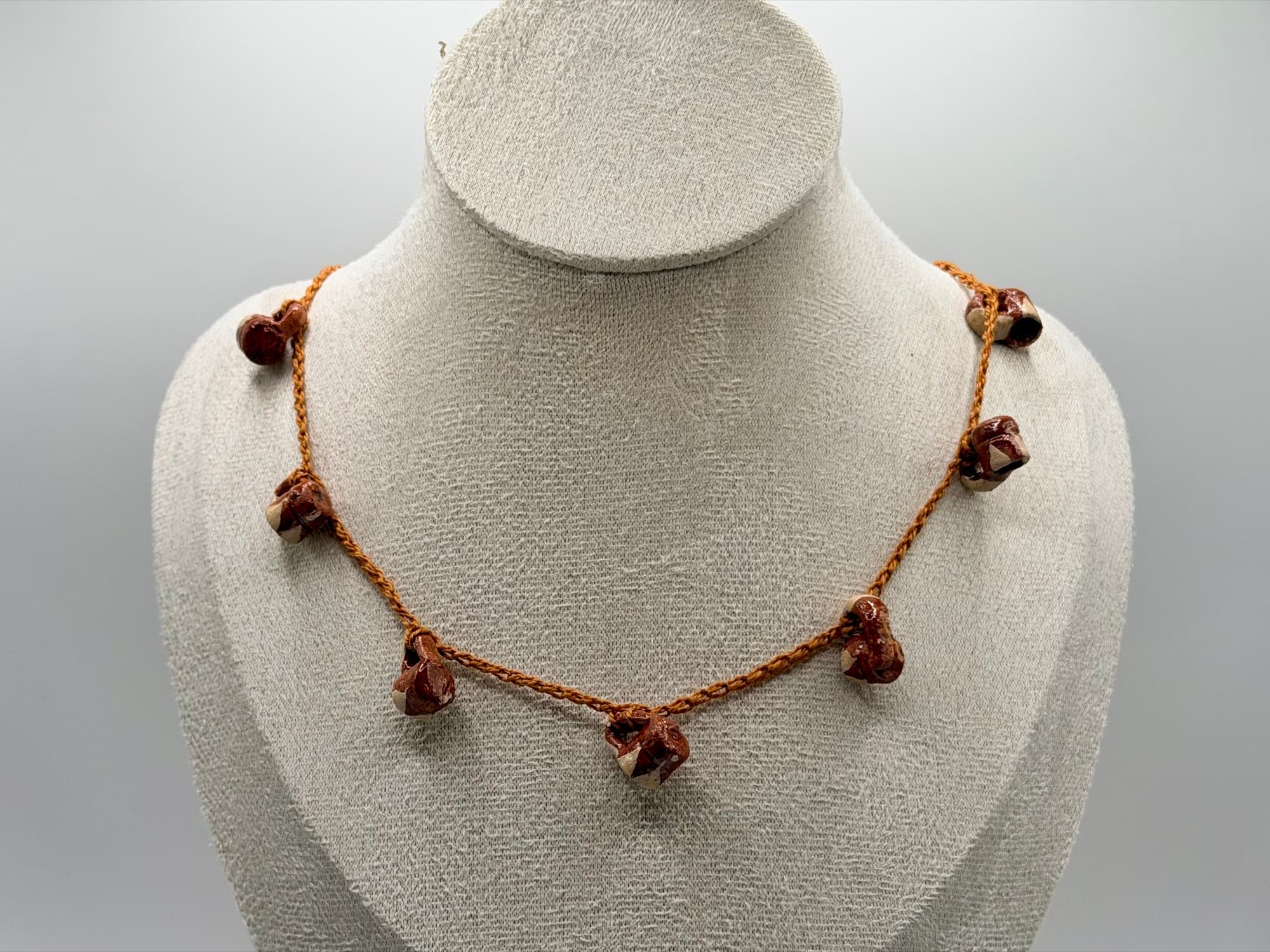 Closer view of Canela y Barro on a necklace bust.