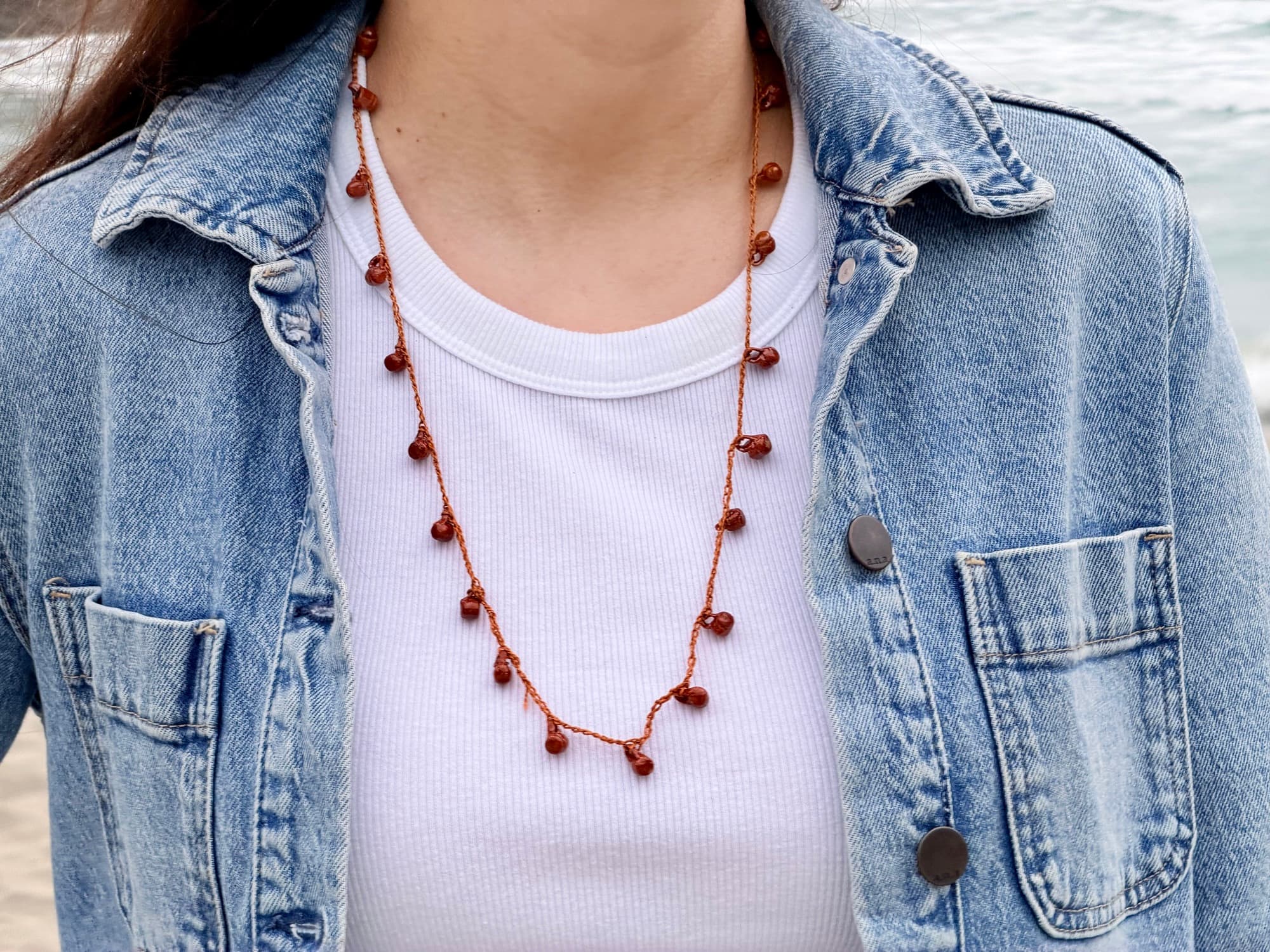 Fiesta de Barro worn with a white top and denim jacket at the beach.