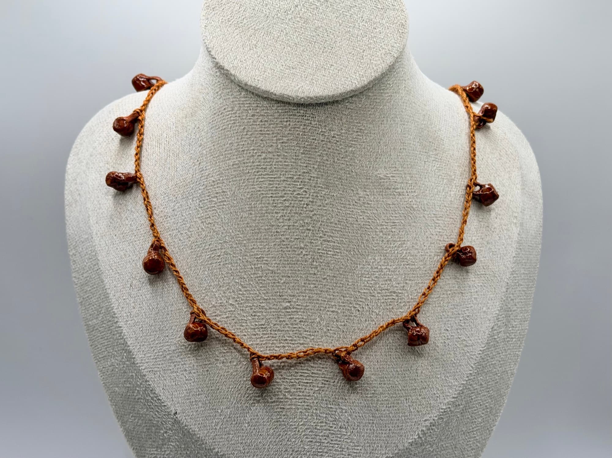 Closer view of Fiesta de Barro on a necklace bust.